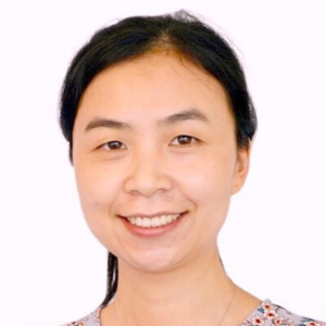 Smiling Asian woman with hair in a ponytail wearing a floral sleeveless blouse