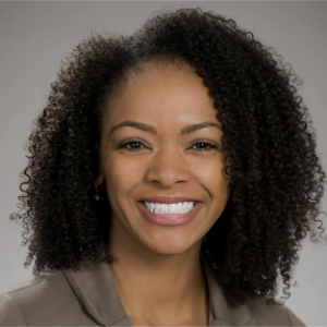 Smiling Black woman with curly shoulder length hair