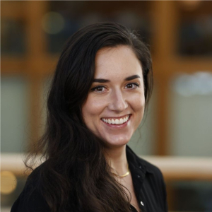 A smiling woman with black hair and a black blouse