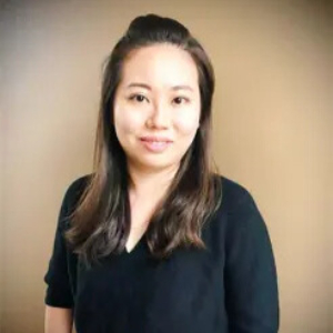 Smiling Asian woman wearing a black blouse