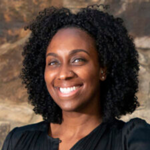 Smiling Black woman wearing a black blouse