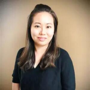 Smiling Asian woman wearing a black blouse