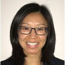 Smiling Asian woman wearing black-rimmed glasses